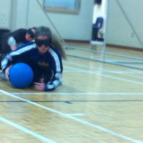 Stephanie slides to her left, blocking & grabbing the ball, while playing centre for the NS women's goalball team.