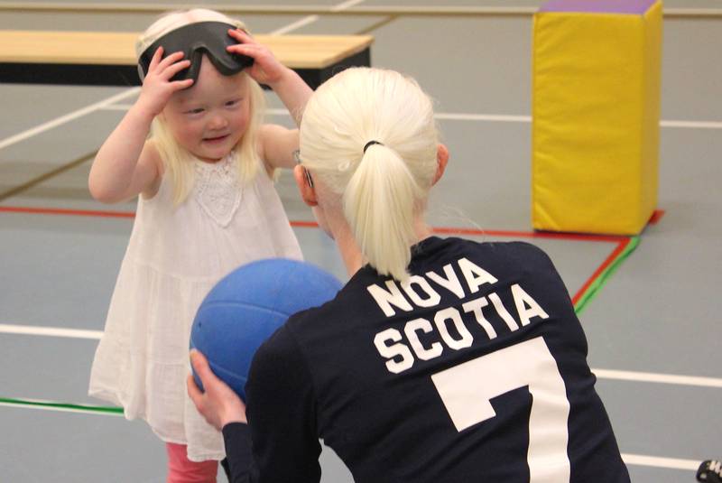 Three-year-old Lily Carmichael takes off her blindfold goggles as she speaks to women’s senior provincial goalball player Jennie Bovard of Halifax. - Contributed