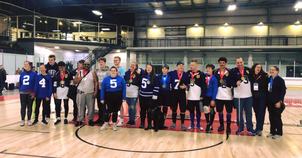 group photo of several athletes wearing medals 