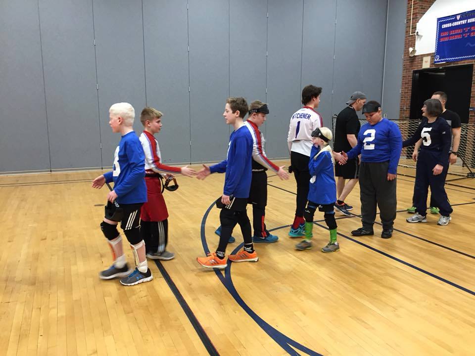 Nova Scotia youth goalball team shakes hands with an opposing team after a game.
