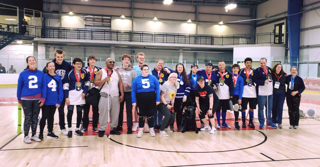 group photo of several athletes wearing medals 